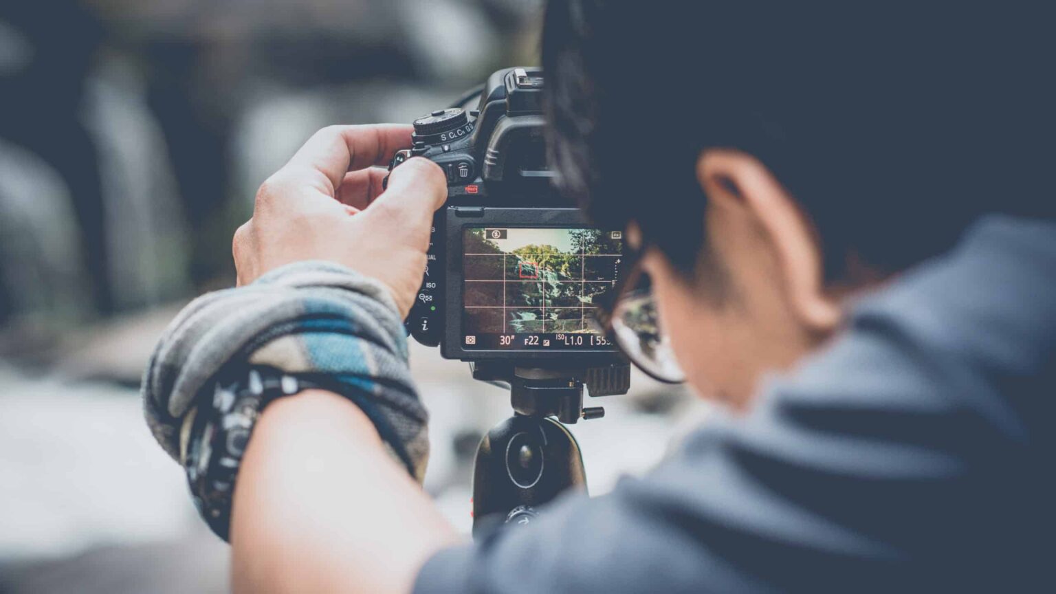 Image of a photographer setting his camera