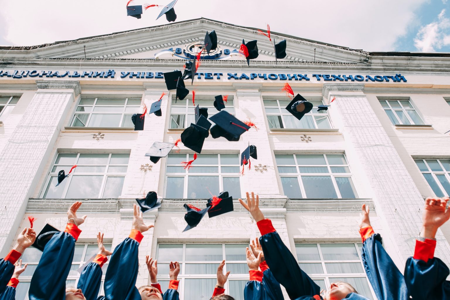 University Graduation Day - Grads through caps in the air